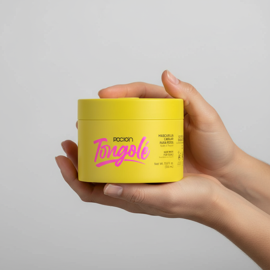 Hand holding a yellow container with pink text against a gray background